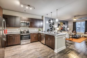 a kitchen with a stove top oven and a sink
