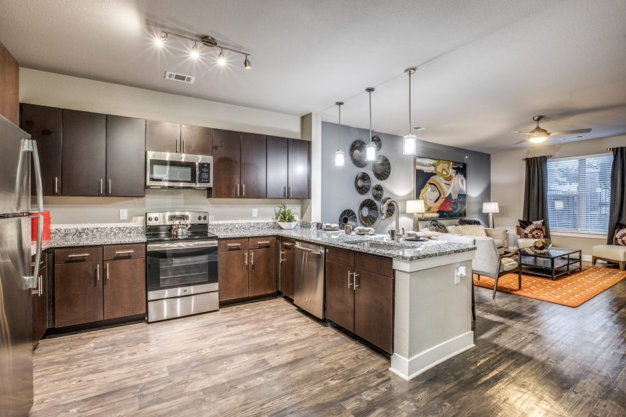 a kitchen with a stove top oven and a sink